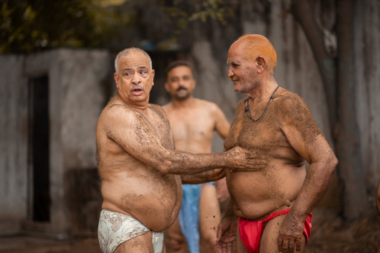 Elderly men engaging in traditional Kabaddi sport, displaying strength and camaraderie in Pakistan.